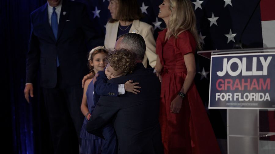 David holds Cece on stage on primary night