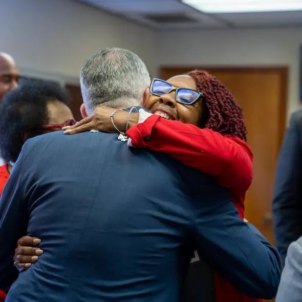 David Jolly embraces a supporter in a red jacket
